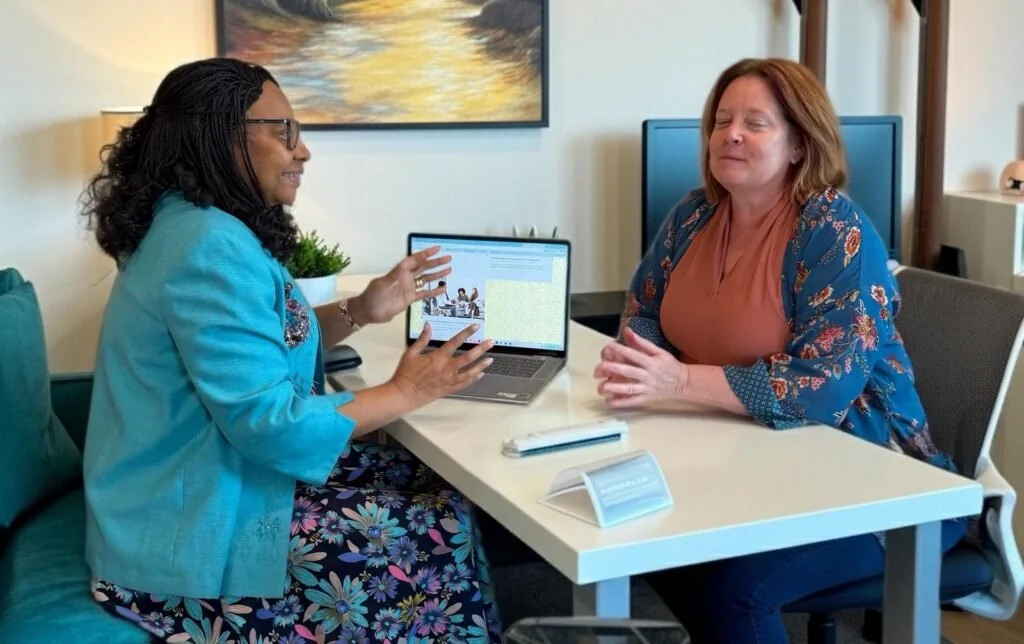 Office conversation photograph from the original practice website